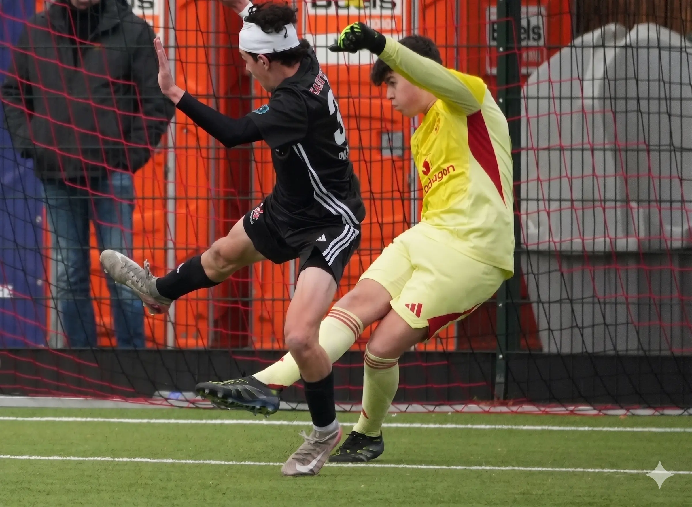 Daylen Hammon in black Real Colorado Eastside FC kit shooting on goal vs Manchester United yellow goalkeeper at Rotterdam Orange Veins Tournament April 2026